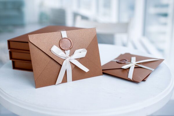 bronze invitation envelope with ribbon and wax seal of gift certificate or wedding card